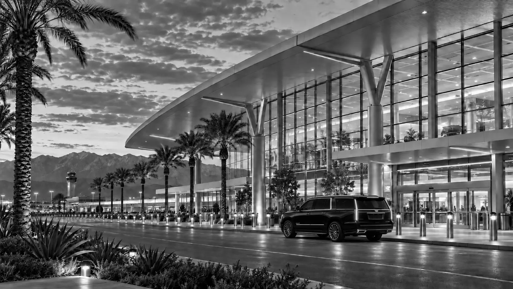 AI illustration of Ontario International Airport with a mountain backdrop and a black Cadillac Escalade at the curb